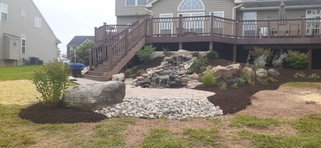 Backyard waterfall and koi pond with stone steps in York County